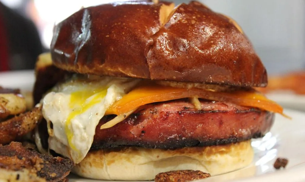 The Berlin Breakfast sandwich at Valter's at the Maennerchor with Bologna, egg, and cheese on a pretzel bun