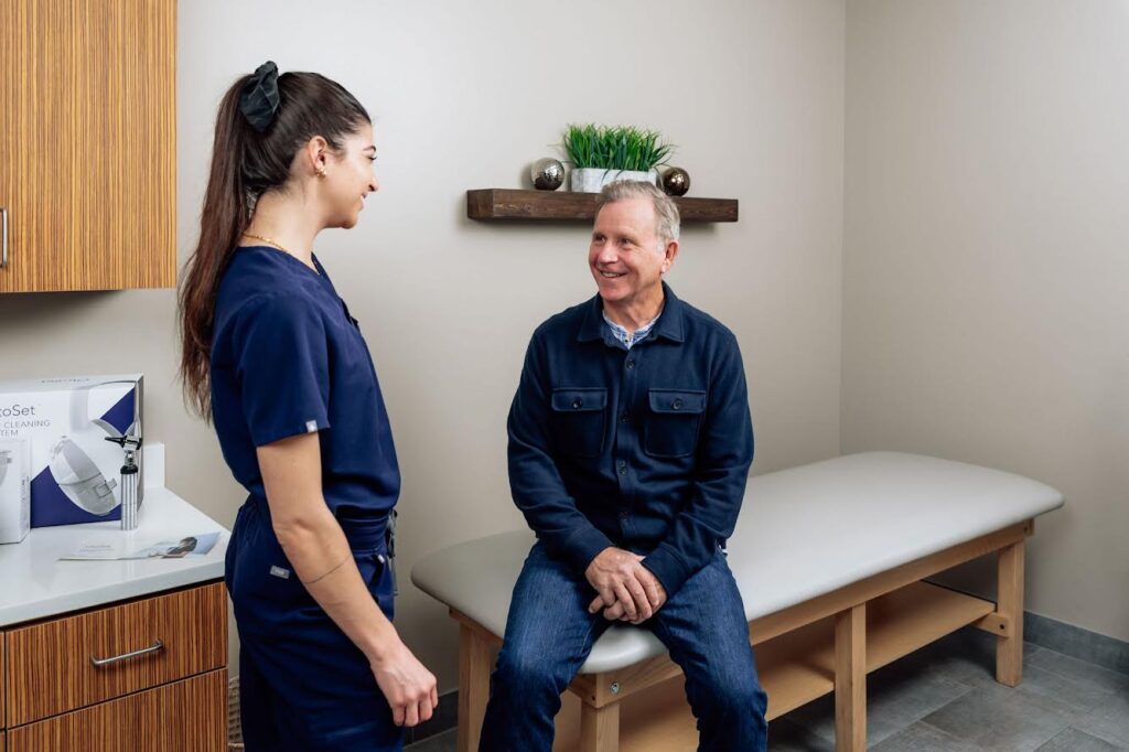 OtoSet clinician walking the patient through the OtoSet ear massage and cleaning experience.