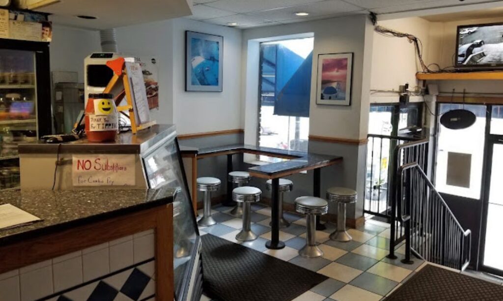 Photo of Apollo's Greek Restaurant's front seating and staircase down to High Street