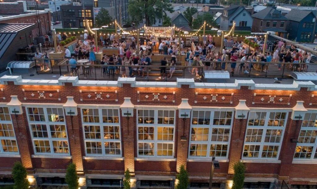 Patrons on a rooftop at Budd Dairy Food Hall in Columbus, Ohio