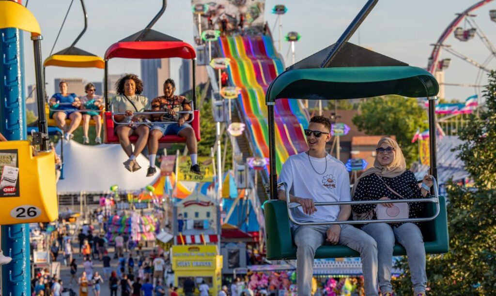 Ohio State Fair patrons look on as they ride the skyride at the Ohio State Fairgrounds