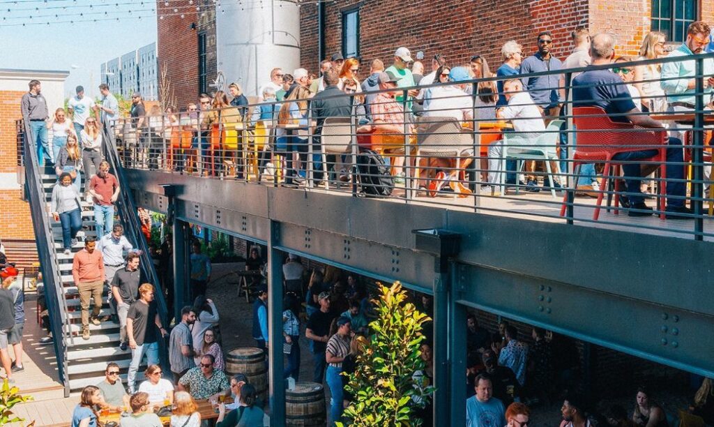 Patrons enjoying the double-decker patio at Jackie O's On Fourth