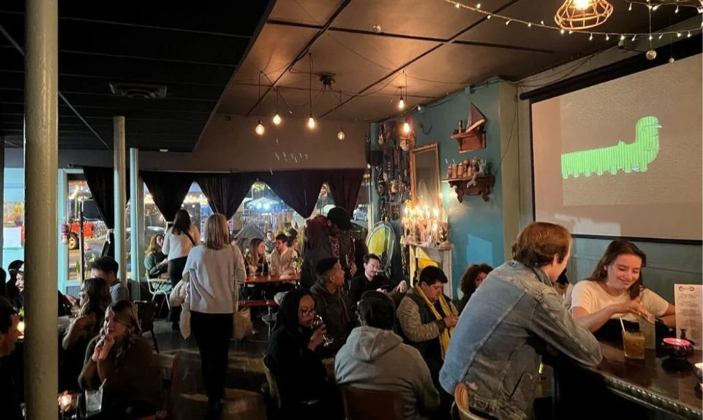 Patrons relaxing and drinking at the Bottle Shop in Victorian Village
