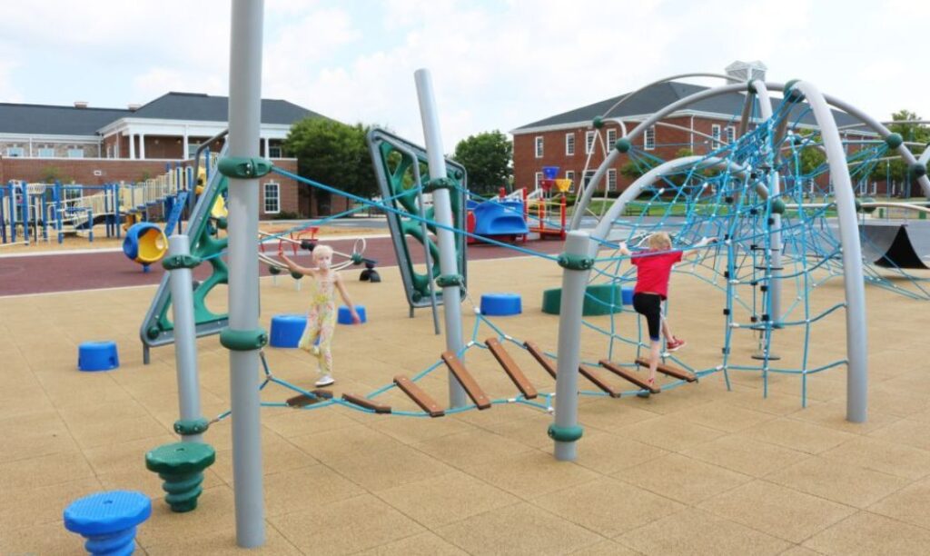 Kids enjoying playground equipment at New Albany-Plain Local Schools' Playground