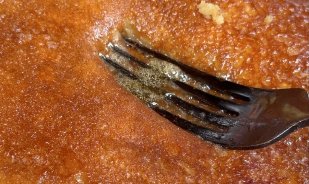 A massive, golden-brown pancake with syrup pooling on top at Mercury Diner in Columbus