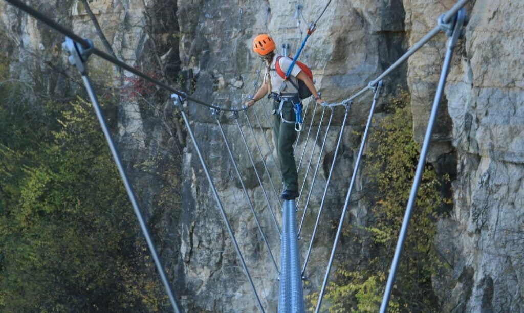 A climber ventures across the 105-foot-high suspension bridge/tight rope at Quarry Trails Metro Park.