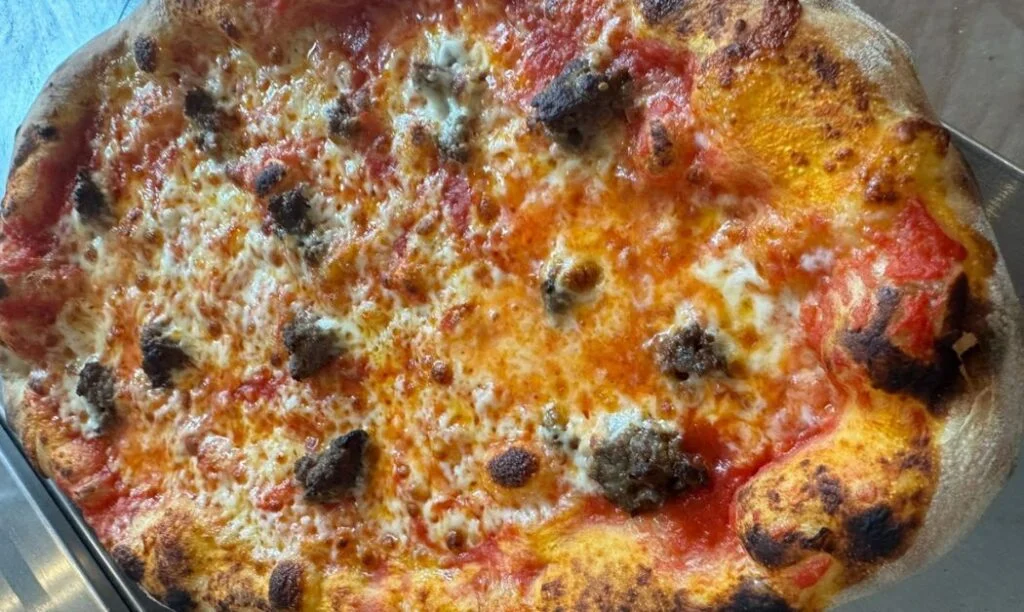 A cheese and meatball pizza from Artisan Pizza Cafe