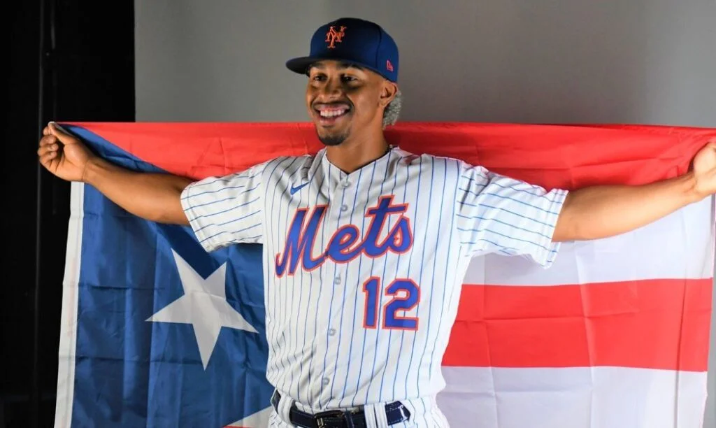 MLB star Francisco Lindor poses with a Puerto Rican Flag. 