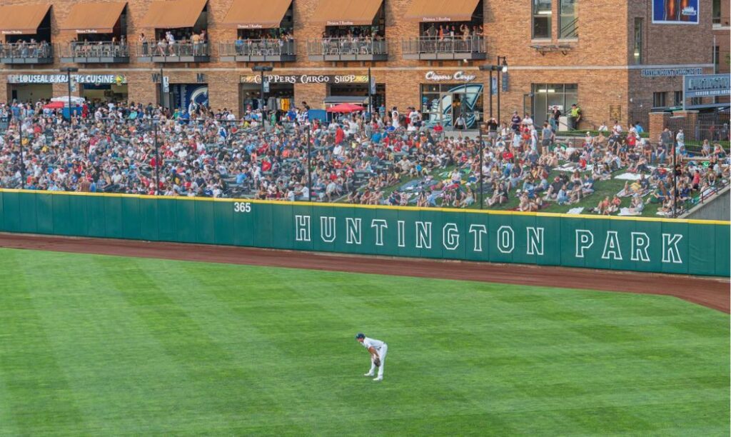 A Columbus Clipper player in Centerfield as an audience watches from the outfield seats at Huntington Park.