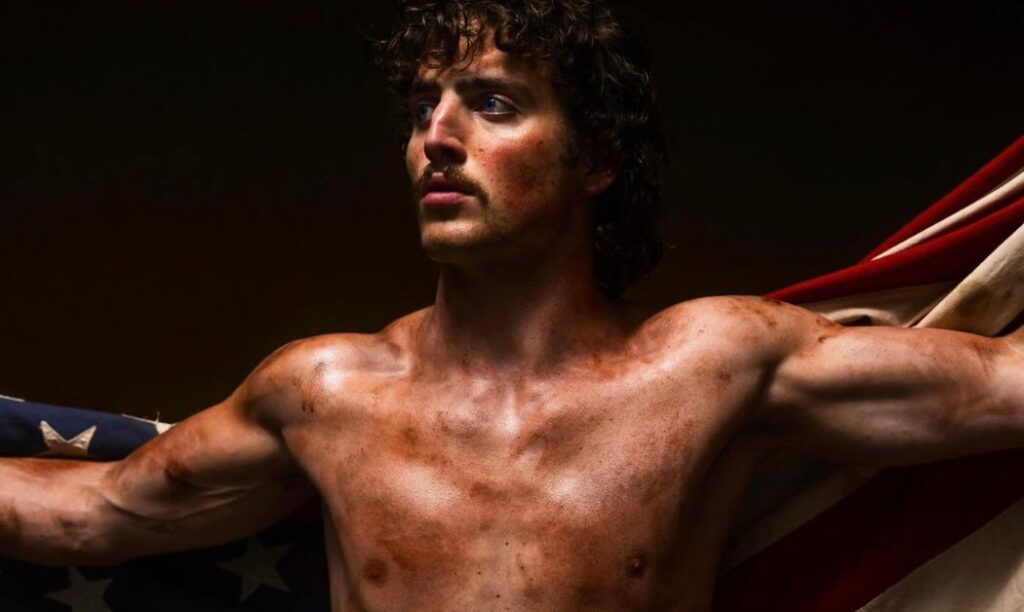 Benson Boone poses with an American Flag as seen on his album American Heart. 