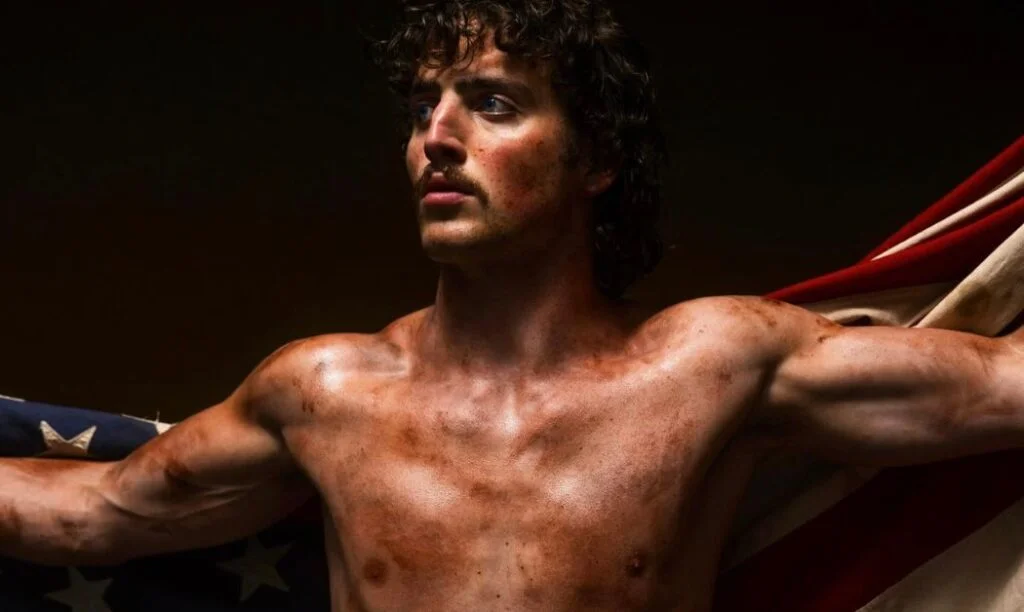 Benson Boone poses with an American Flag as seen on his album American Heart. 