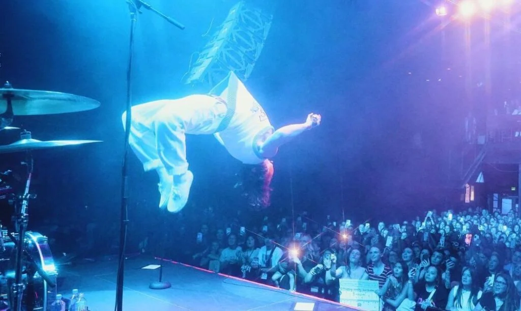 Benson Boone doing a backflip on stage