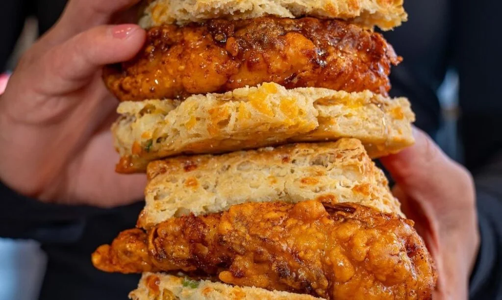 Two chicken sandwich biscuits stacked atop one another