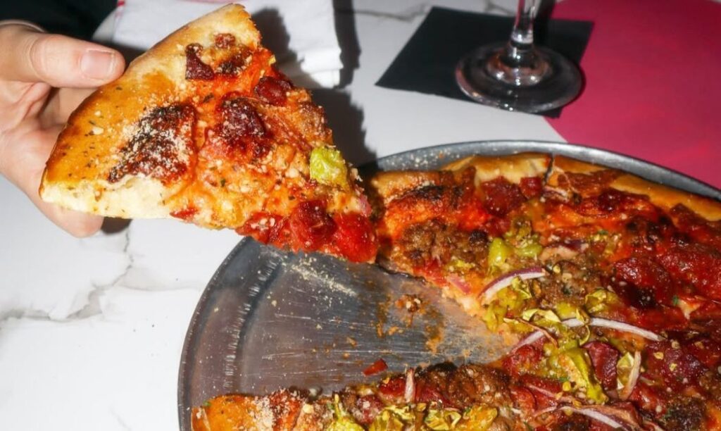 Grabbing a slice of pizza.