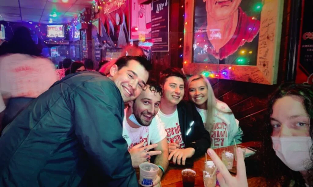 College friends enjoying drinks at Bier Stube during Senior Crawl. 