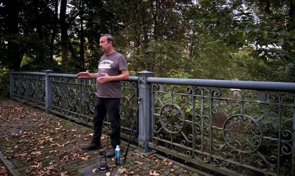 E.R. "Bucky" Cutright from Columbus Ghost Tours tells a story from the bridge at Green Lawn Cemetery in Columbus, Ohio.