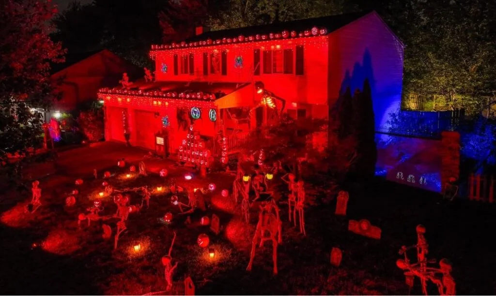 Red light is cast on the home at 2691 Sawmill Meadows Ave in Dublin, OH for their annual Halloween light show.